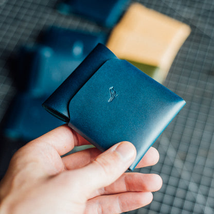 Blue Pattern - Cash Emerson Wallet: Closed wallet held by a man's hand, with bills and cards neatly tucked inside