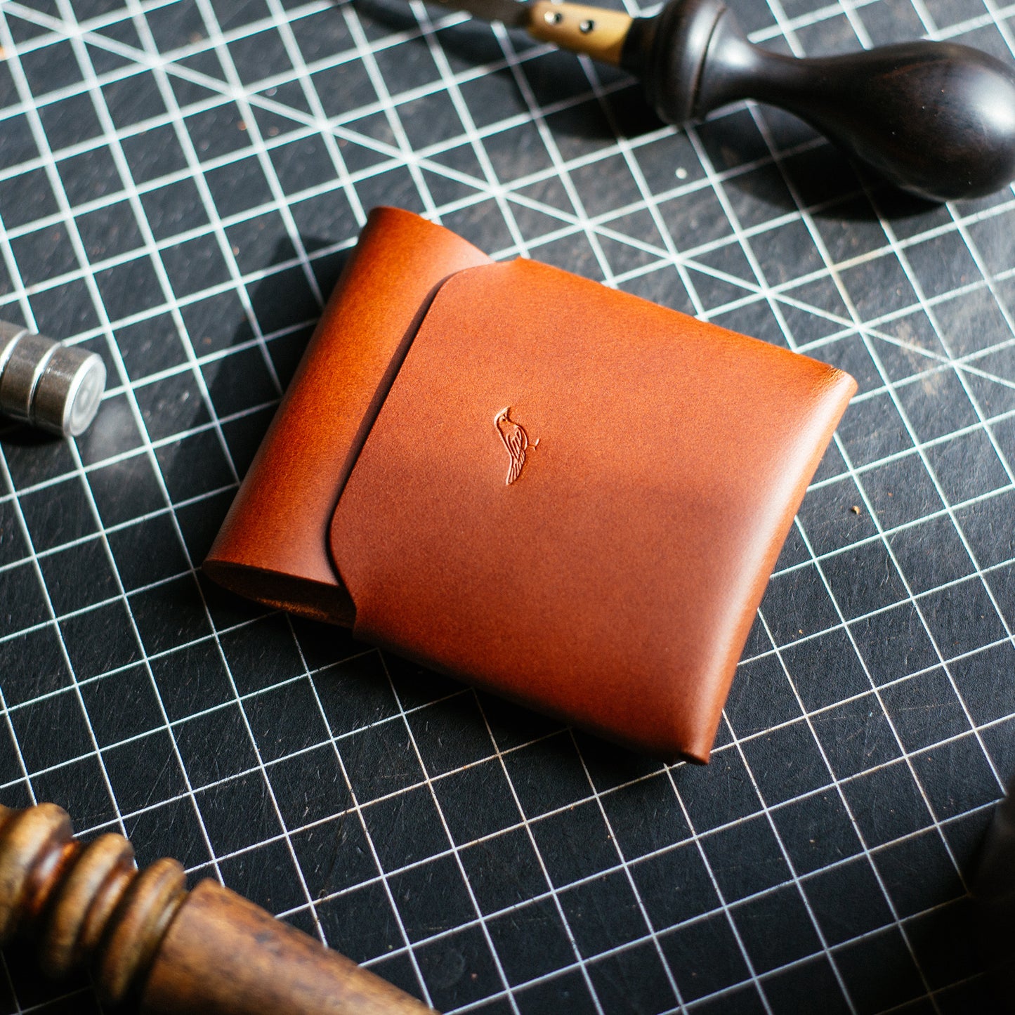 Brown Cash Emerson Wallet on a worktable with tools nearly
