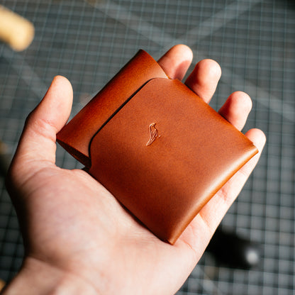 Pattern - Cash Emerson Wallet: Closed wallet held by a man's hand, with bills and cards neatly tucked inside